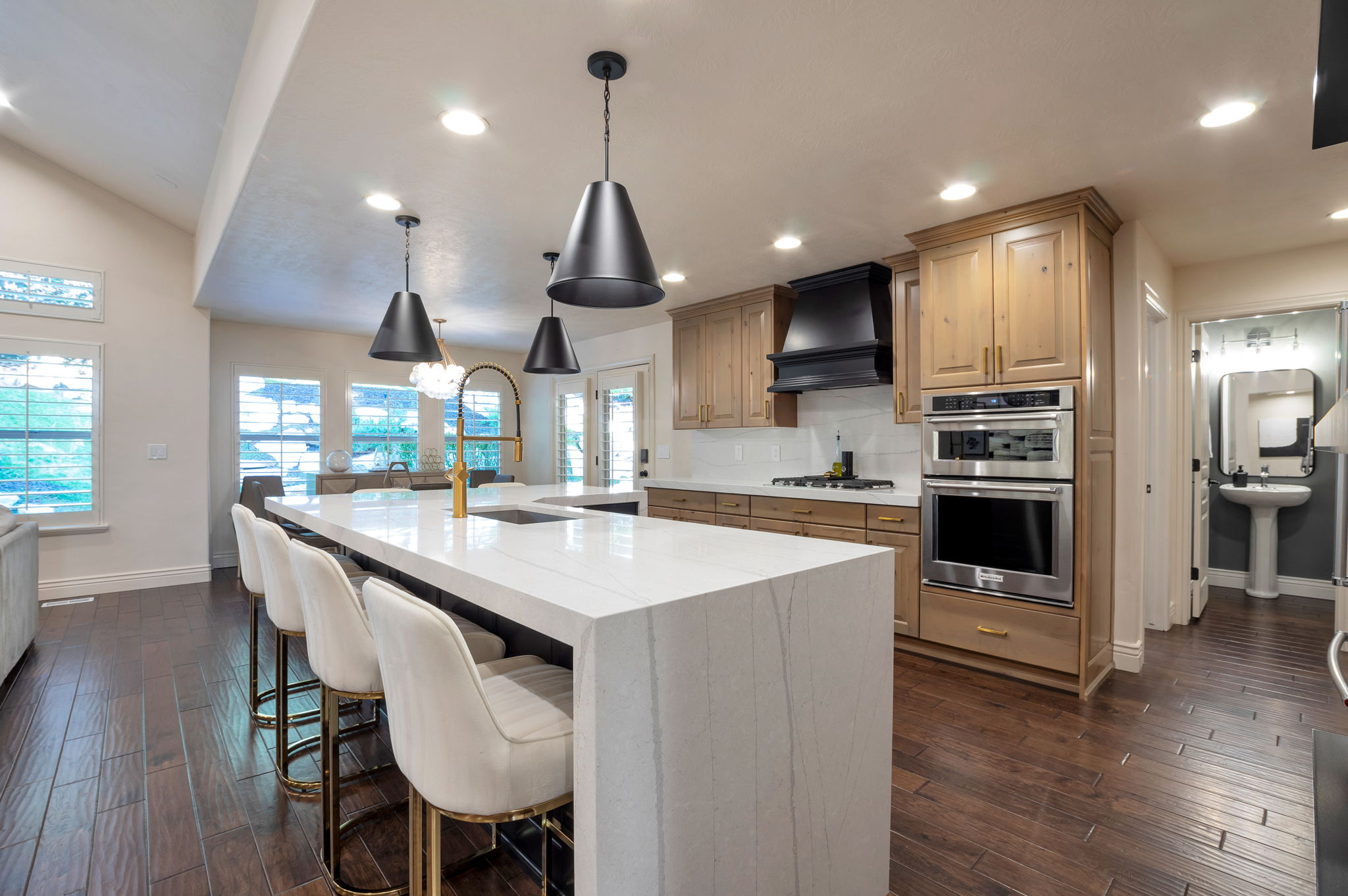 Custom kitchen featuring premium finishes, abundant cabinetry, double ovens, and generous prep space.