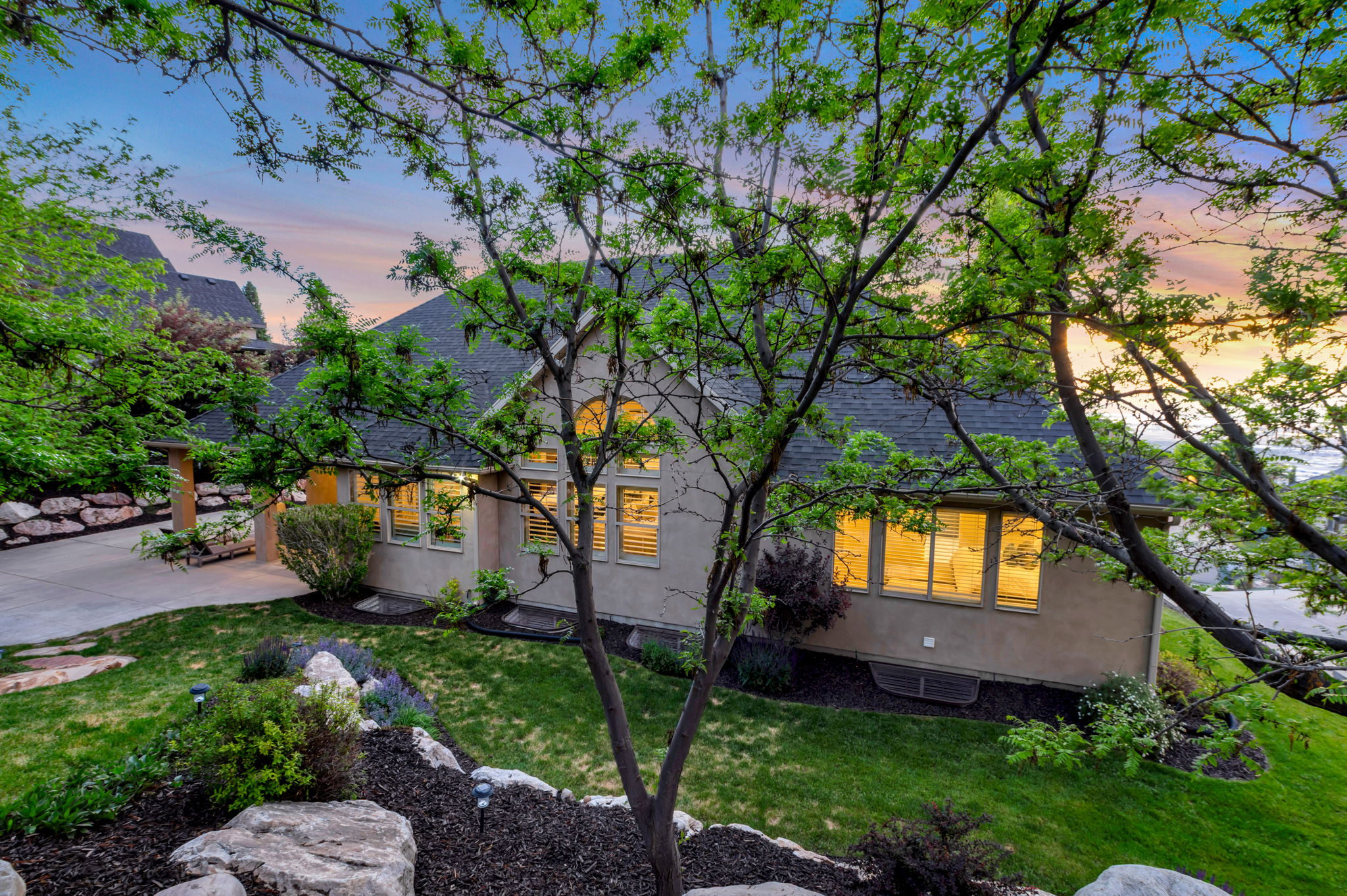 A peaceful backyard sanctuary surrounded by mature landscaping, natural shade, and beautifully maintained grounds.