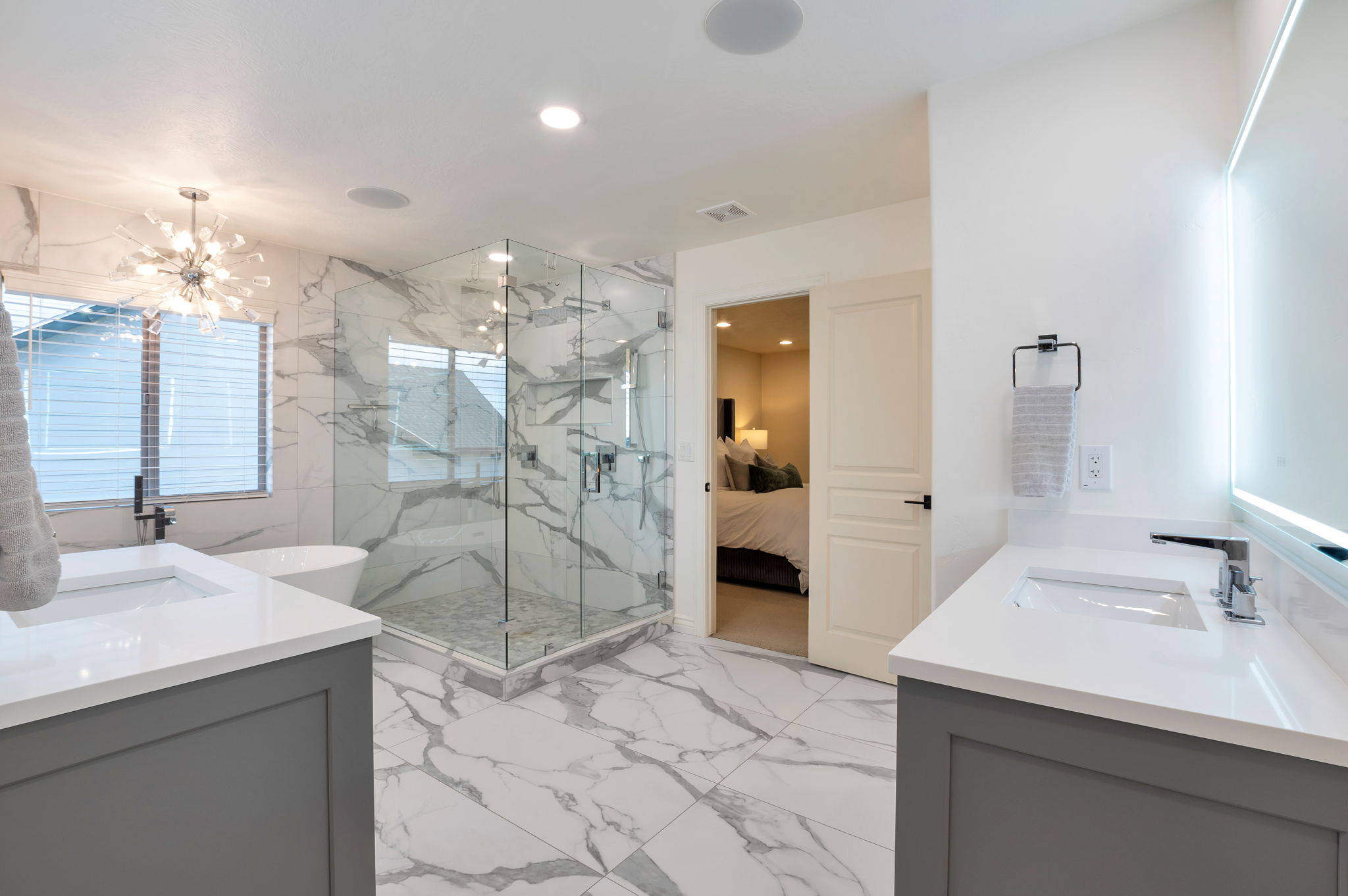 Beautifully renovated spa bath featuring a freestanding soaking tub, oversized walk-in shower, and designer finishes throughout.