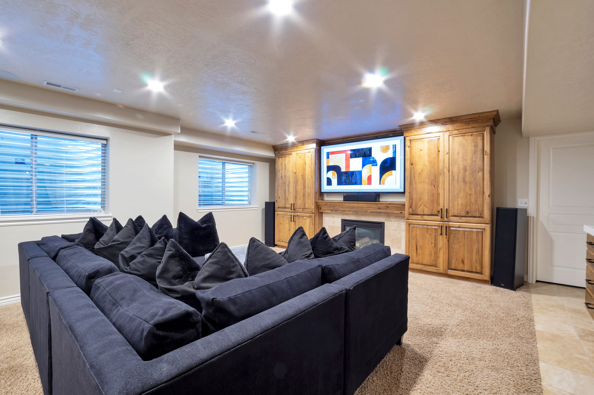 Custom media wall with built-in cabinetry creates the perfect home theater experience.