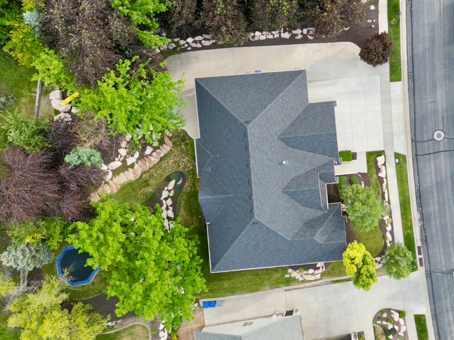 Expansive, tree-lined homesite with mature landscaping, extensive rockscaping, and exceptional privacy. The thoughtfully designed yard is surrounded by towering trees that create a secluded, park-like setting rarely found in the area.