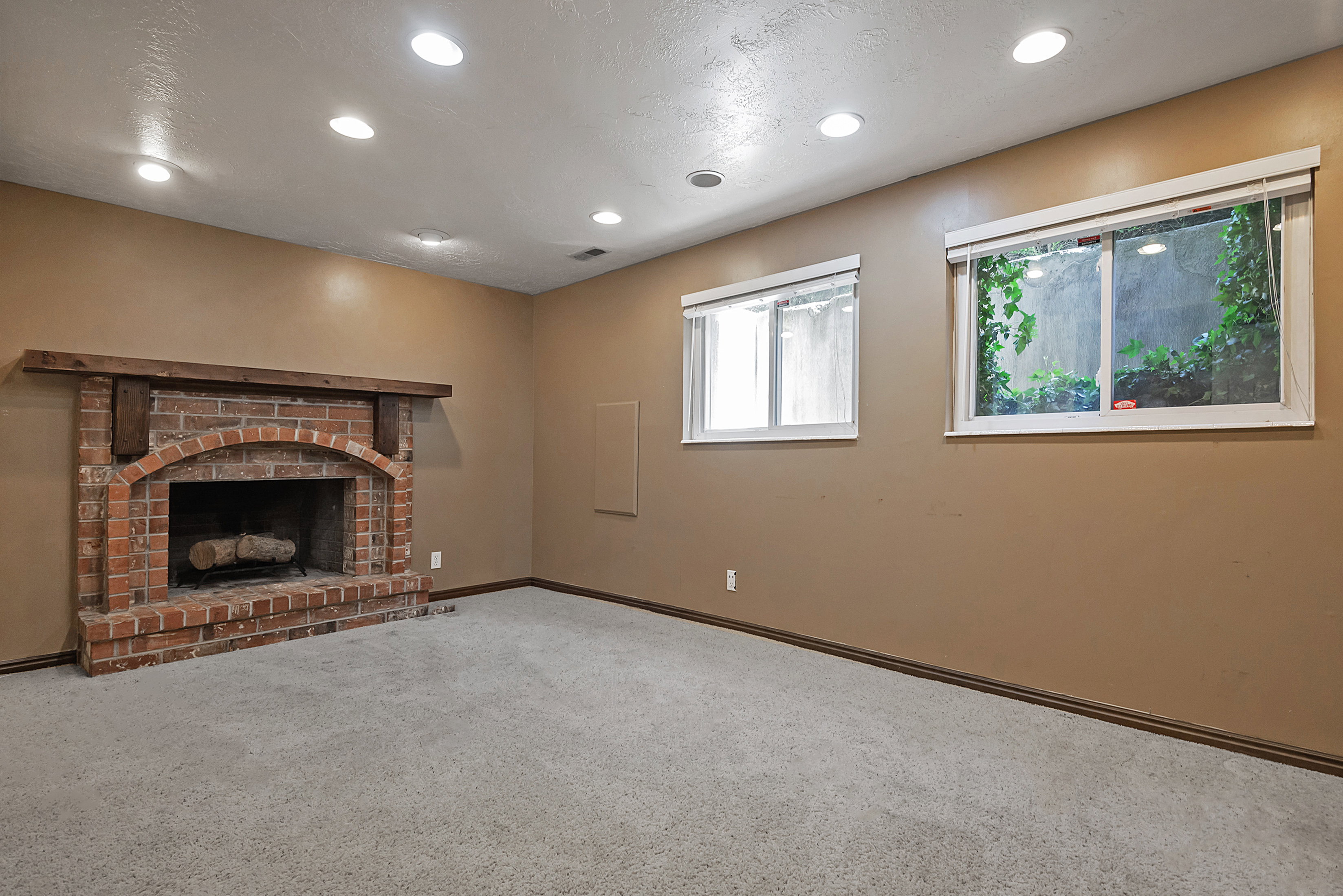 Brick fireplace with a substantial wood mantel