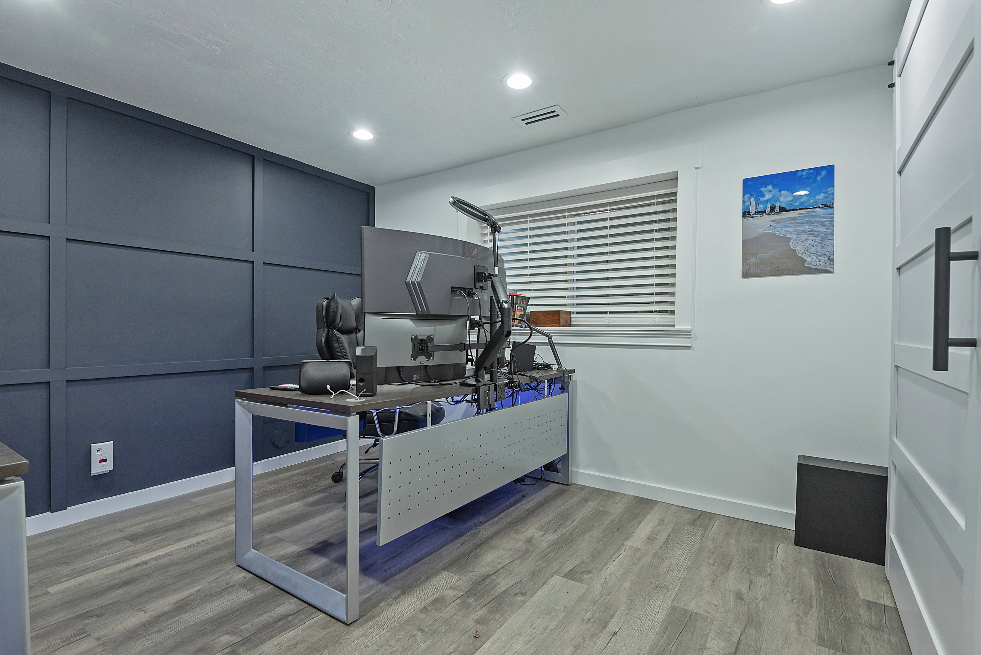 Accent wall with board and batten detailing, recessed lighting, wood-finish flooring, and a window with blinds