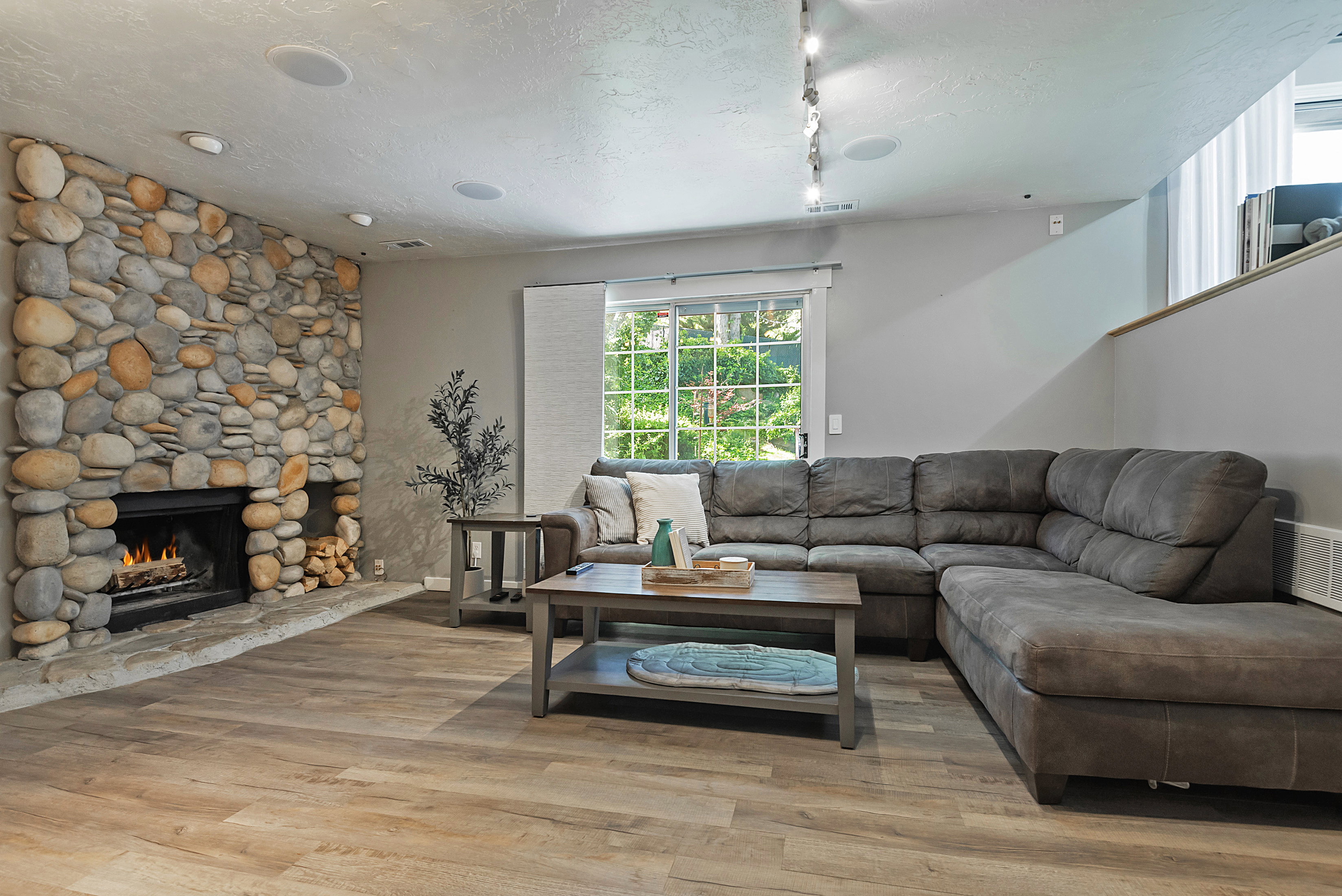 Stone-faced fireplace with a hearth and wood storage niche