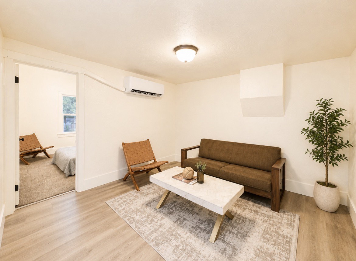 Unit 2 living room. Light wood-finish flooring complements neutral wall tones