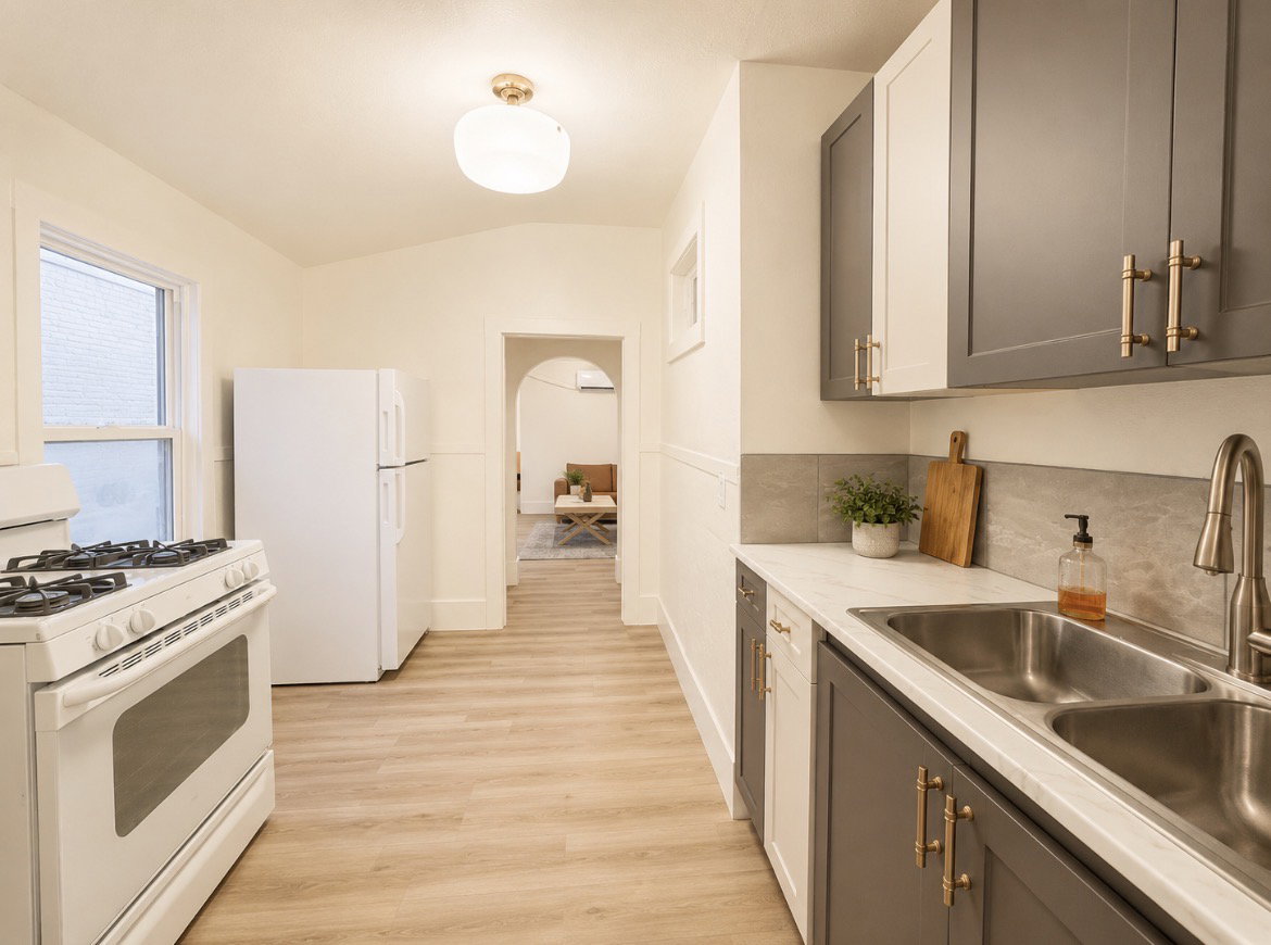 Unit 2 Kitchen featuring light wood-finish flooring, white appliances, and a dual-basin stainless steel sink