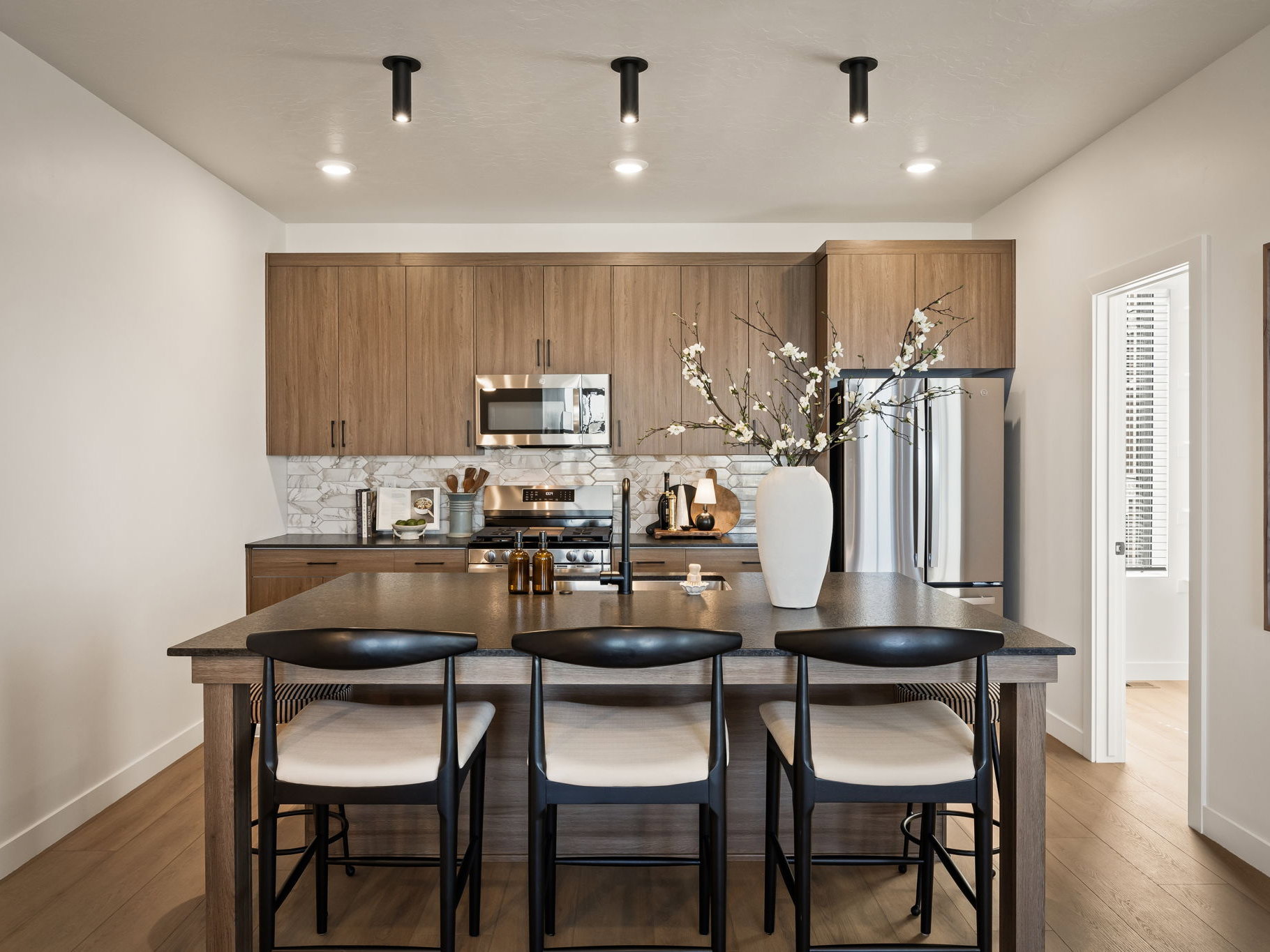Spacious kitchen island featuring a dark countertop and three-seat capacity