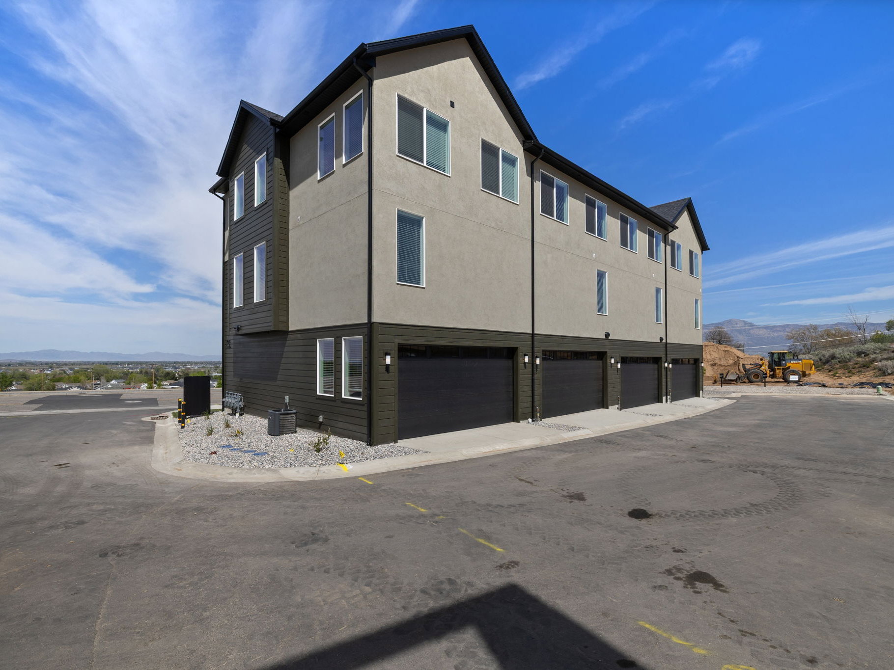 Modern multi-story facade featuring stucco and horizontal siding