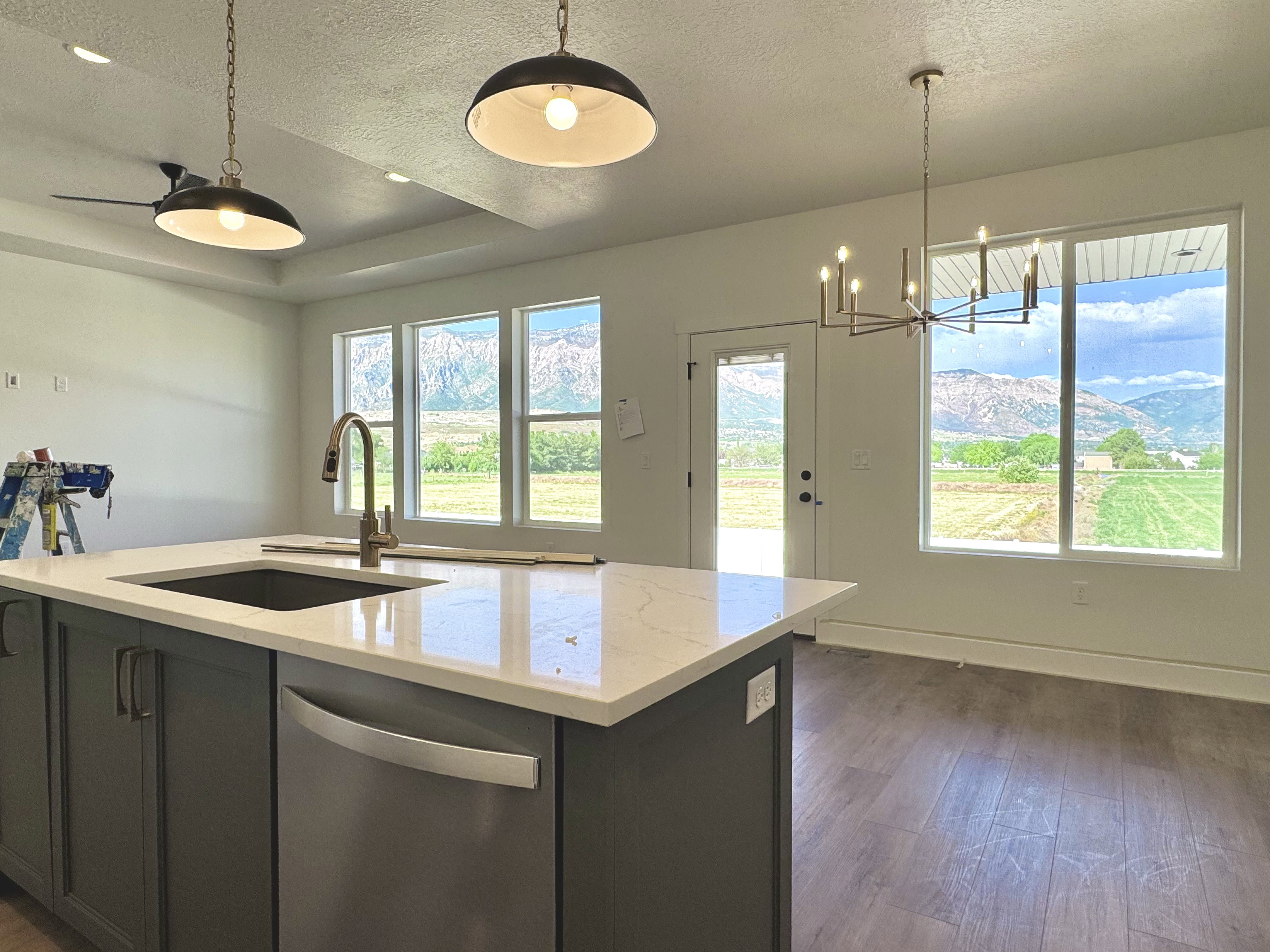 Kitchen island with a built-in sink and stainless steel dishwasher