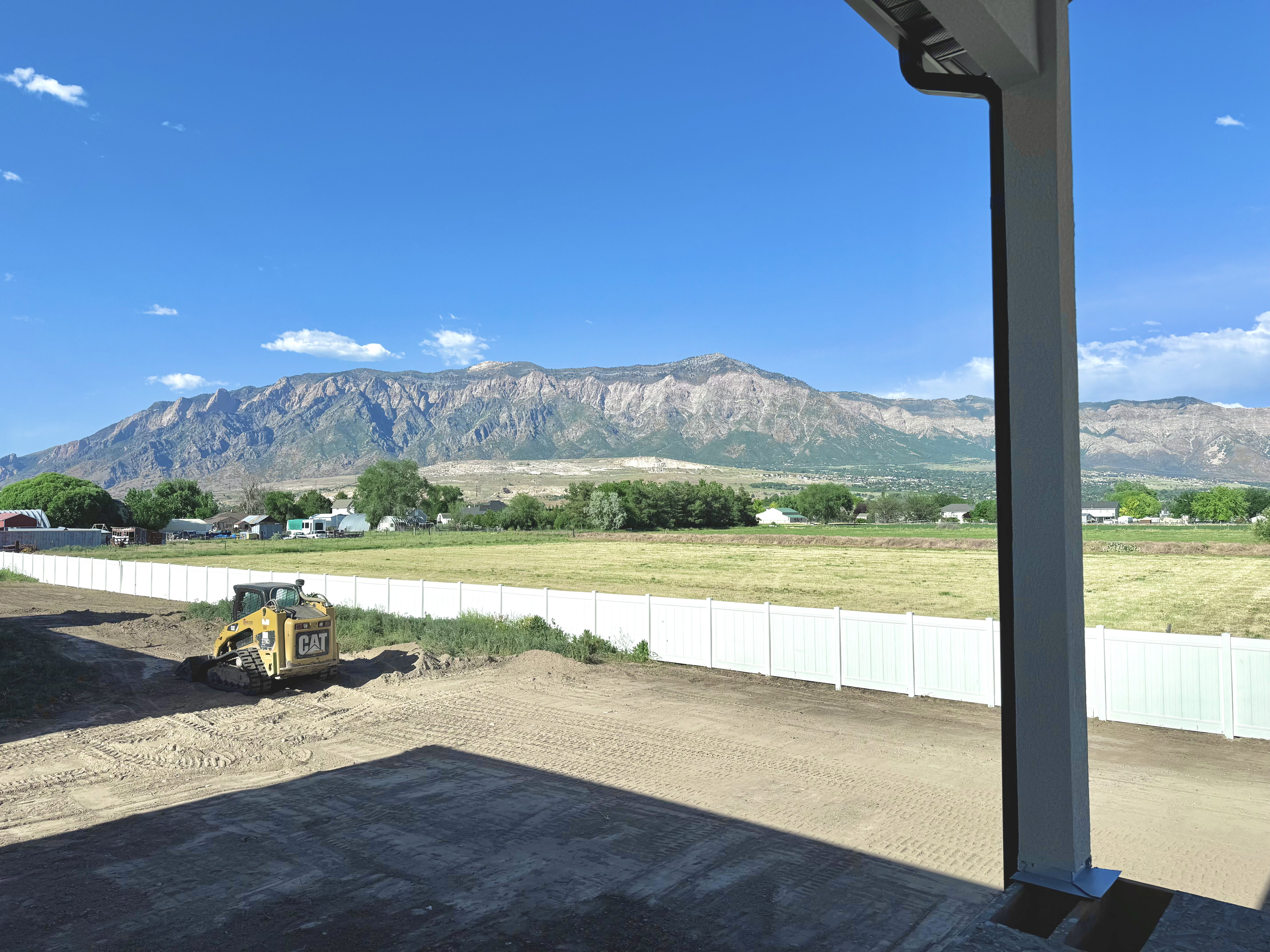 Mountain range backdrop with a partially graded lot