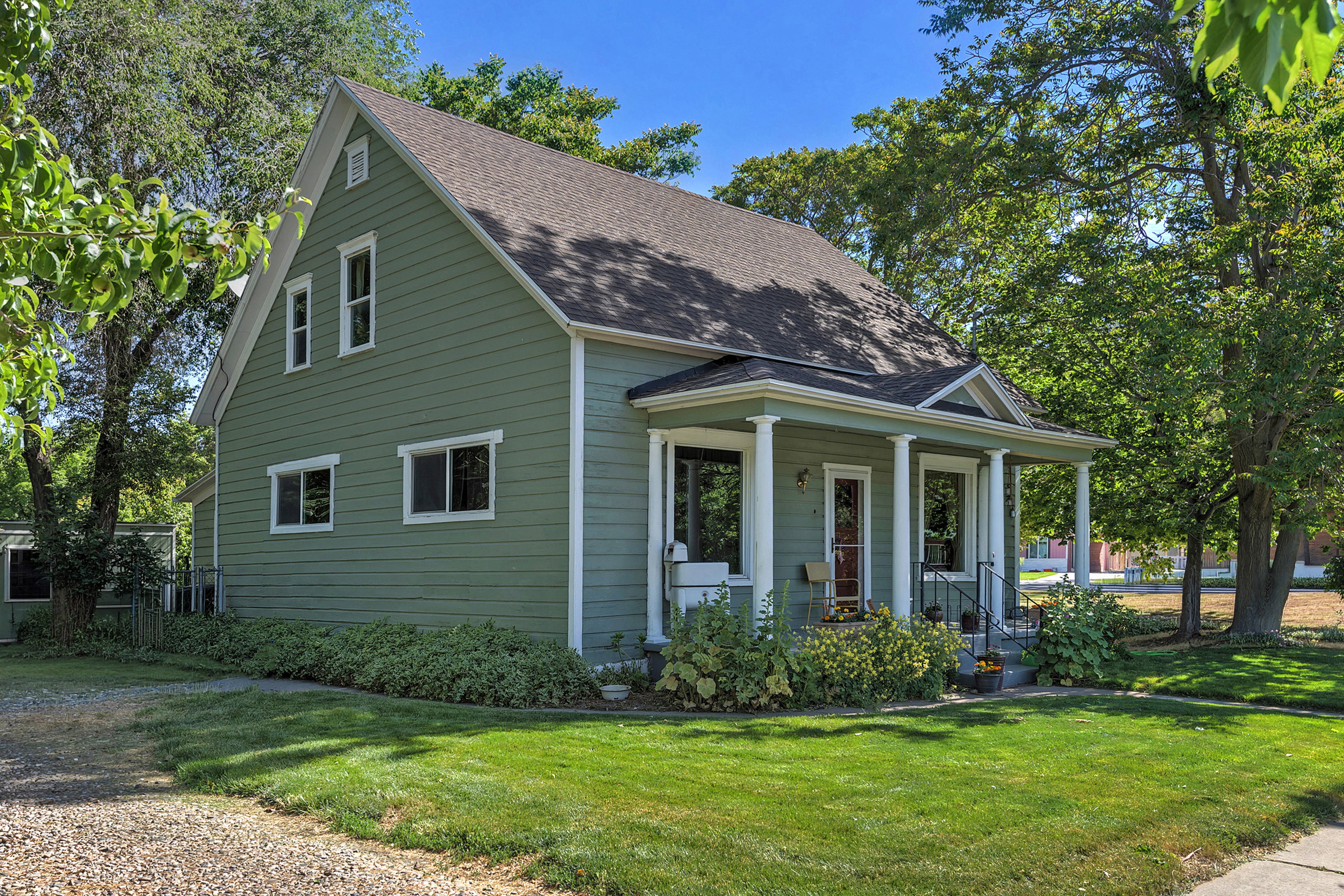 Traditional-style residence featuring a prominent covered front porch with white columns