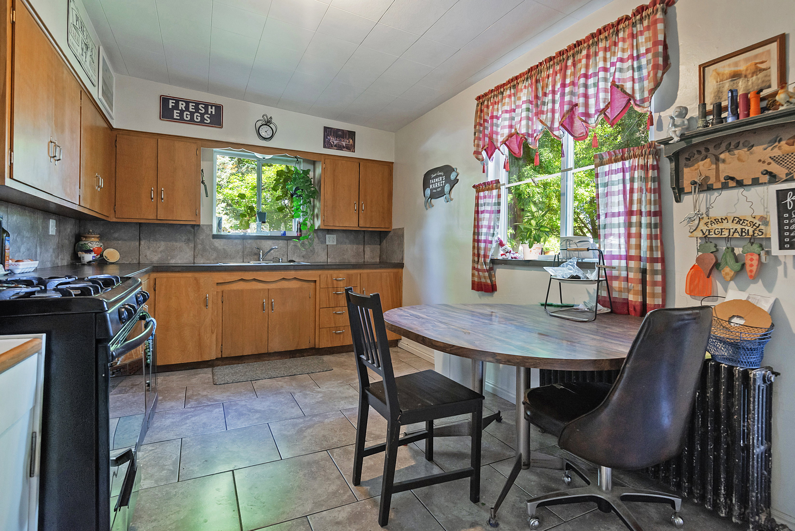 Kitchen featuring wood cabinetry, a built-in sink, and tile flooring