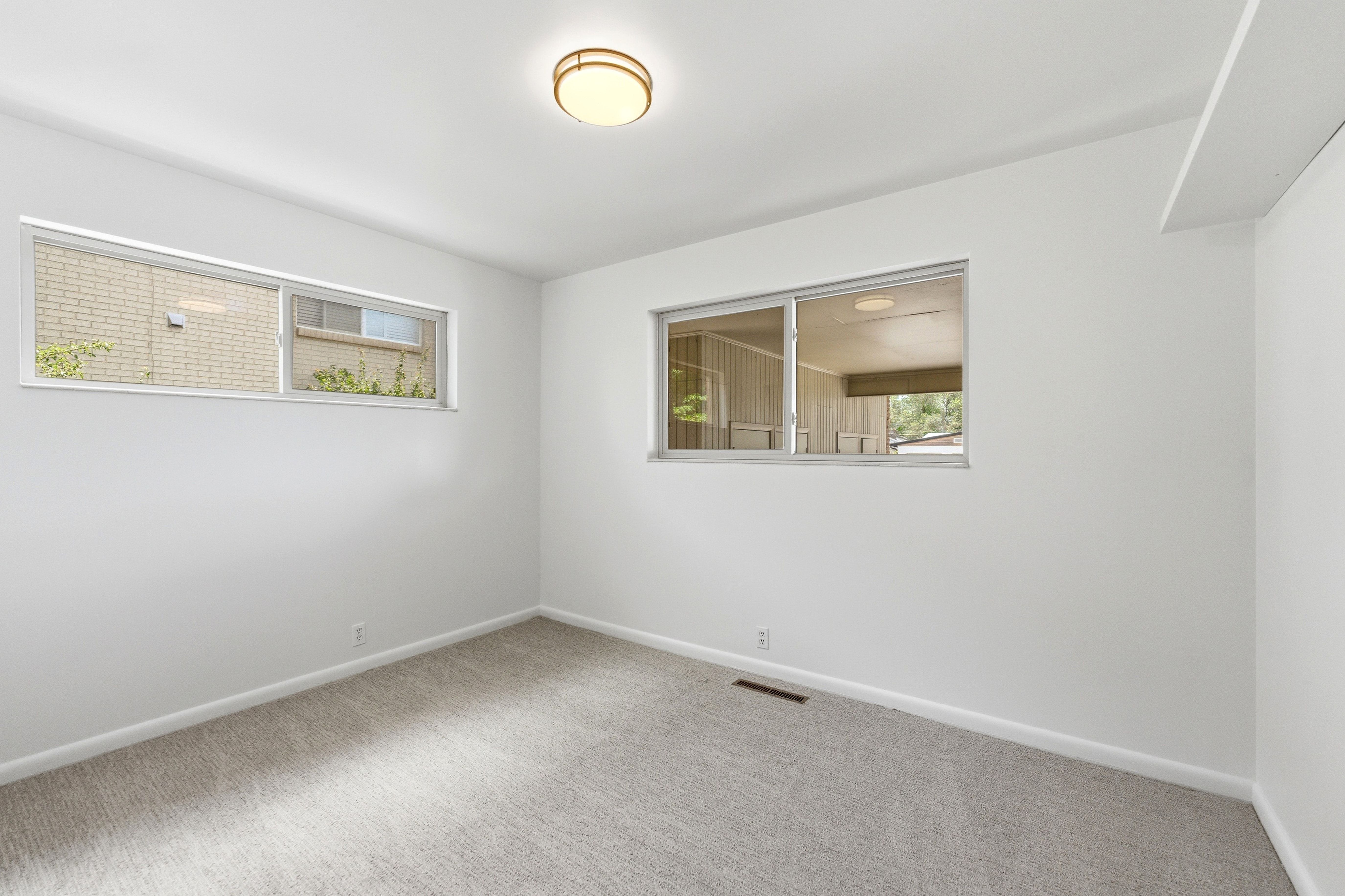 White-painted room featuring light gray carpet flooring