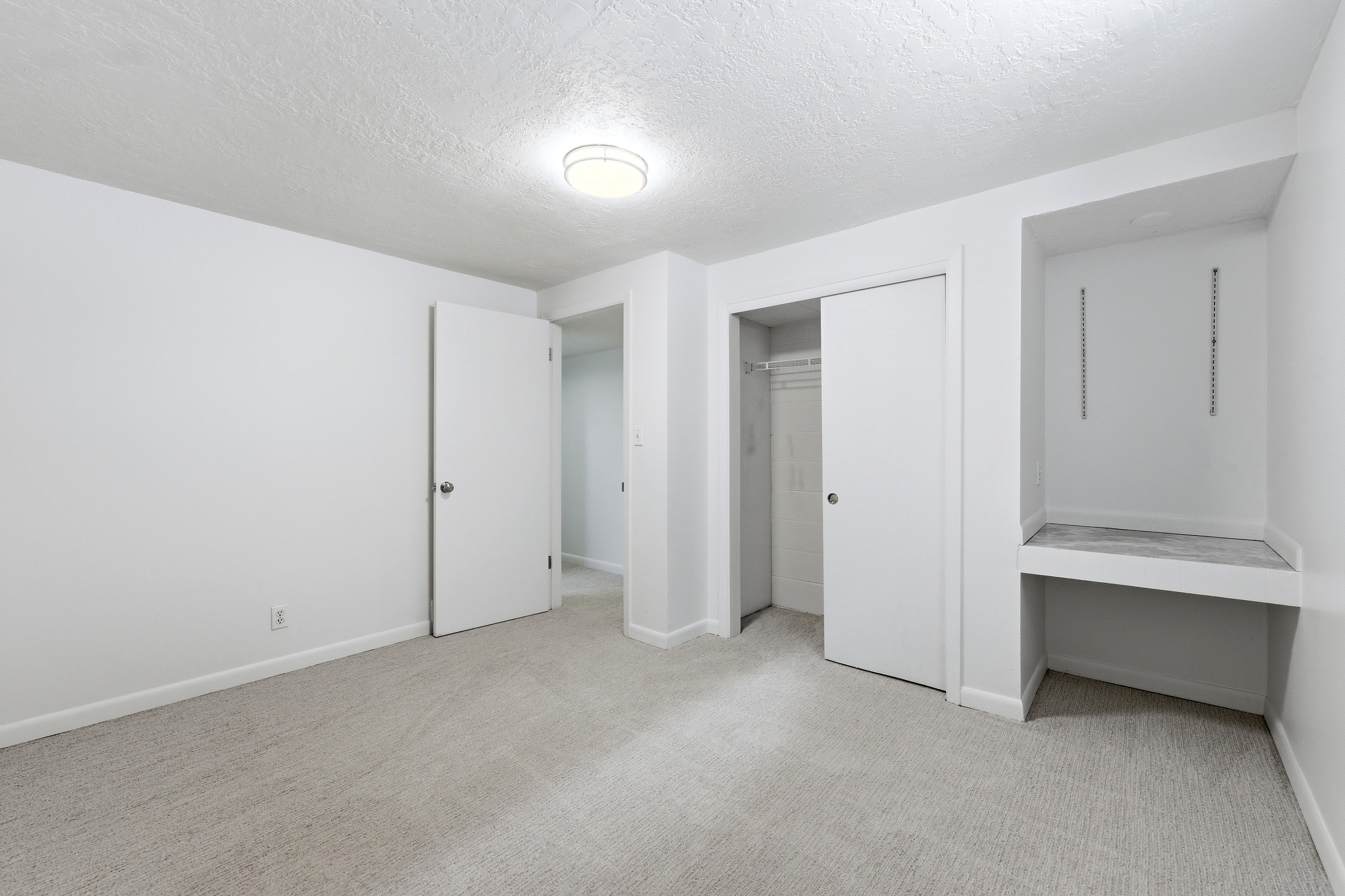 Neutral-toned carpeting paired with white walls