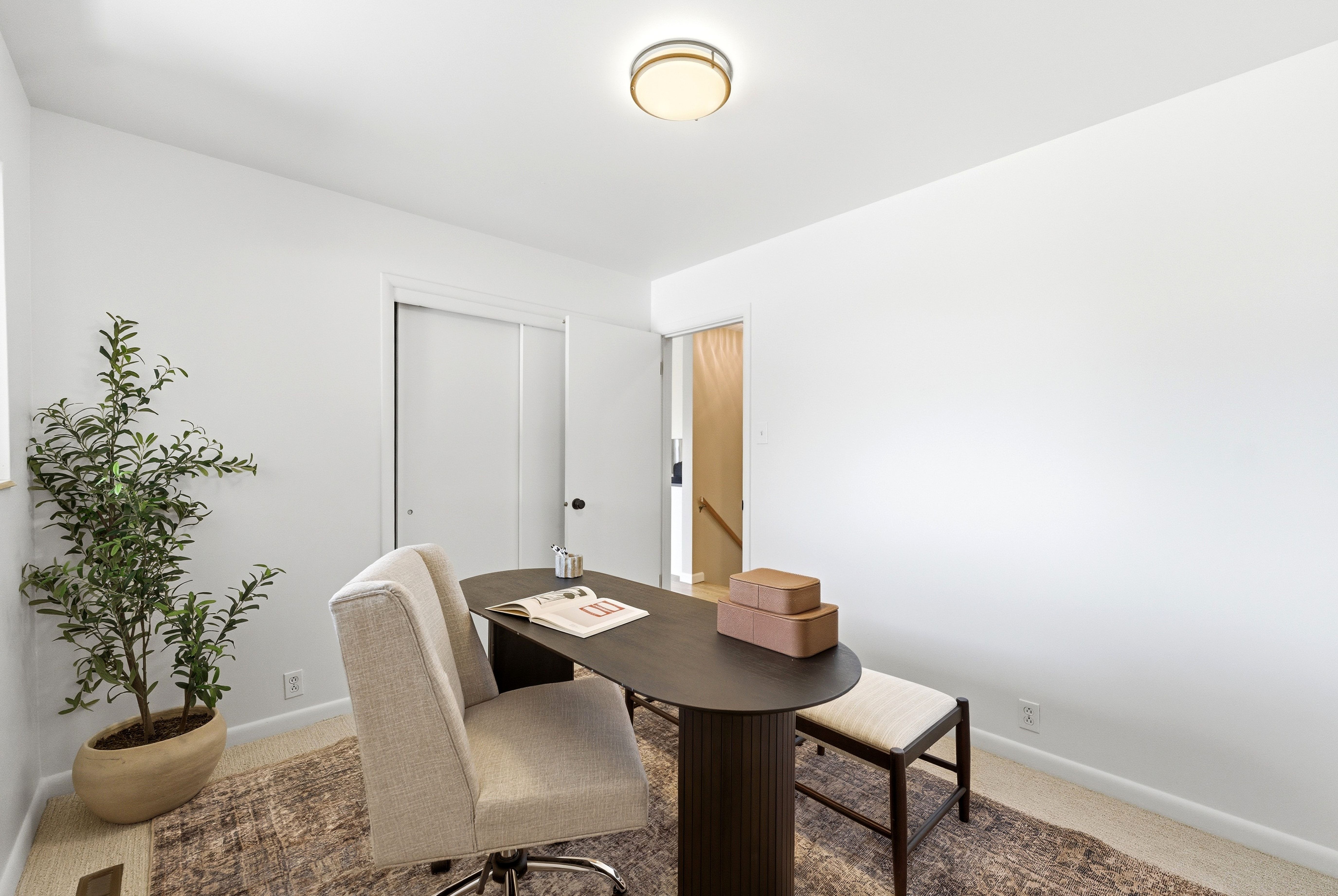 Bright room with white painted walls, featuring a sliding double-door closet