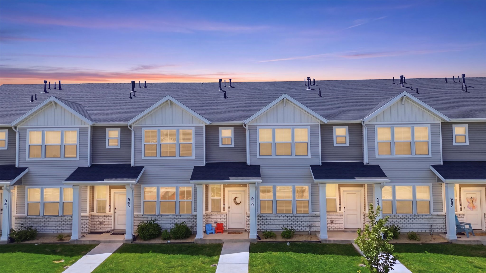 Contemporary townhome exteriors featuring light gray siding and white trim