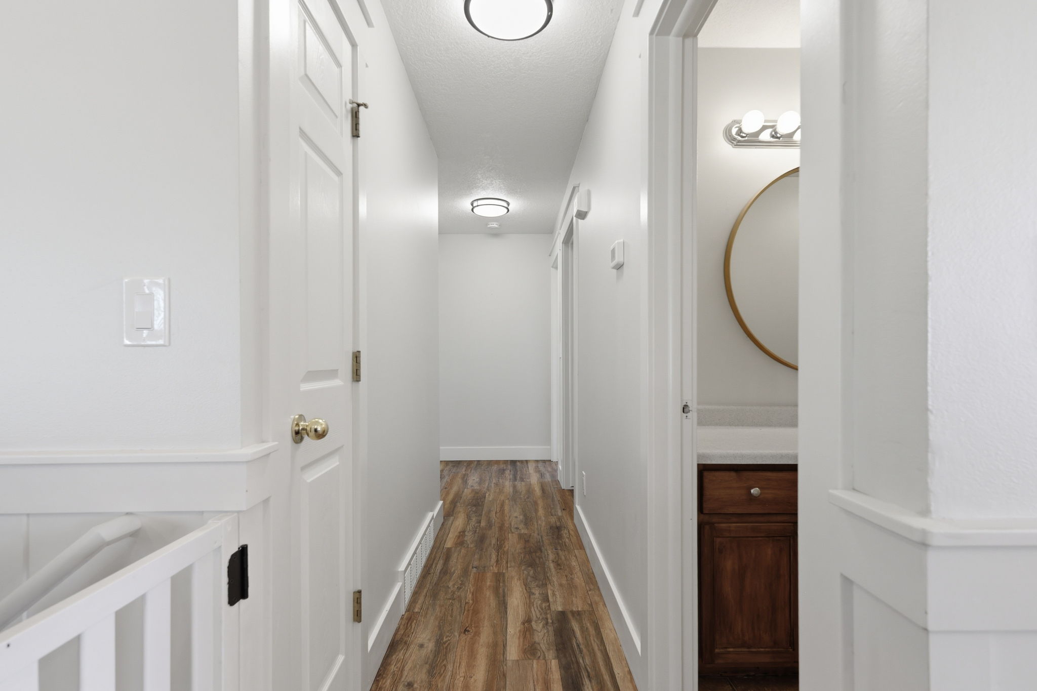 Hallway featuring wood-finish flooring and flush-mount ceiling lights