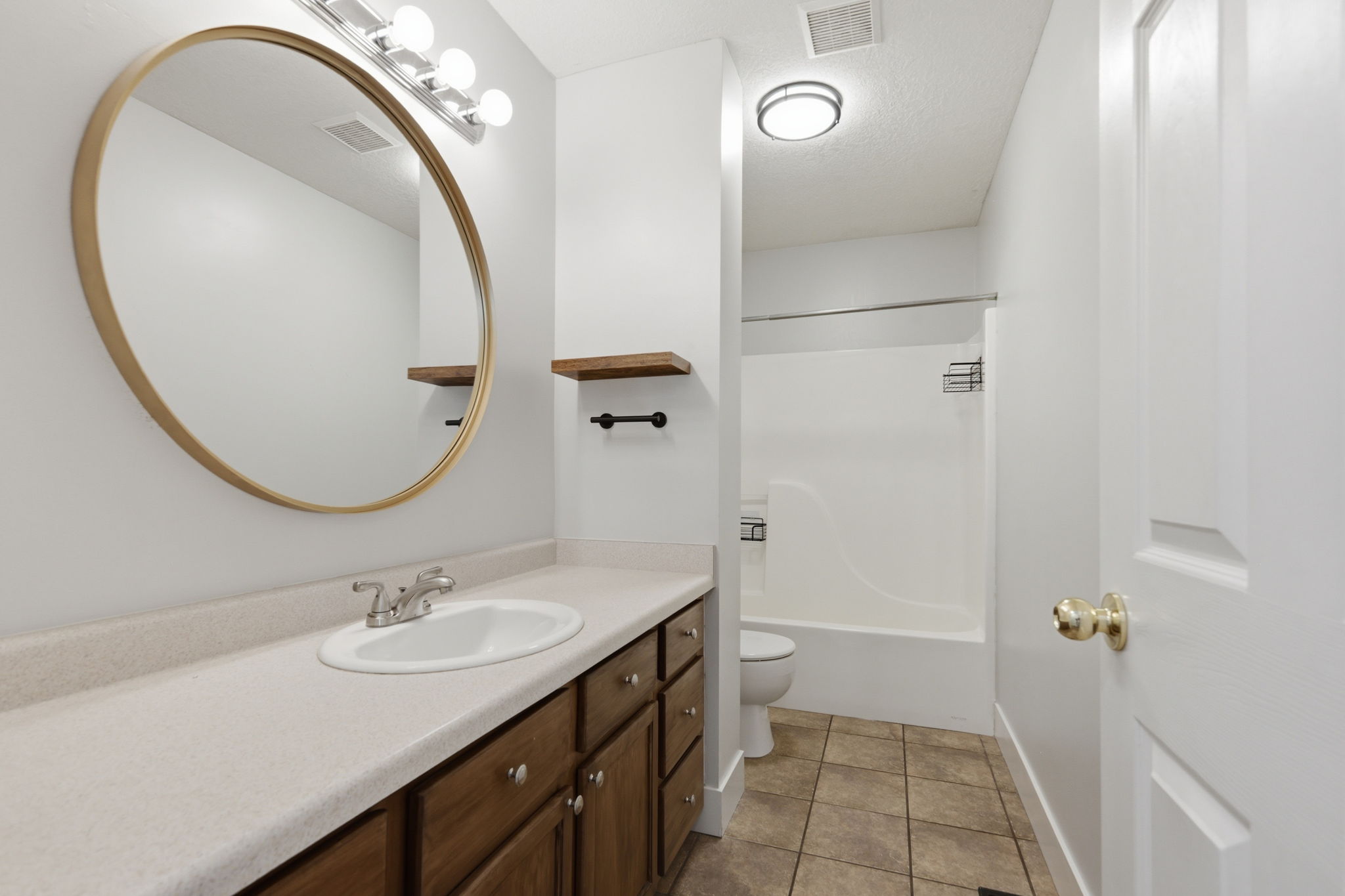 Full bathroom with a tub/shower combination, vanity with integrated sink, and wood-finish cabinetry