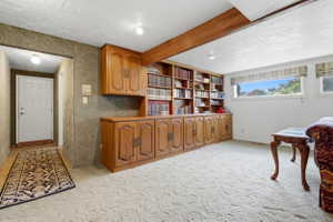Integrated wood-finish cabinetry and shelving unit with brass hardware