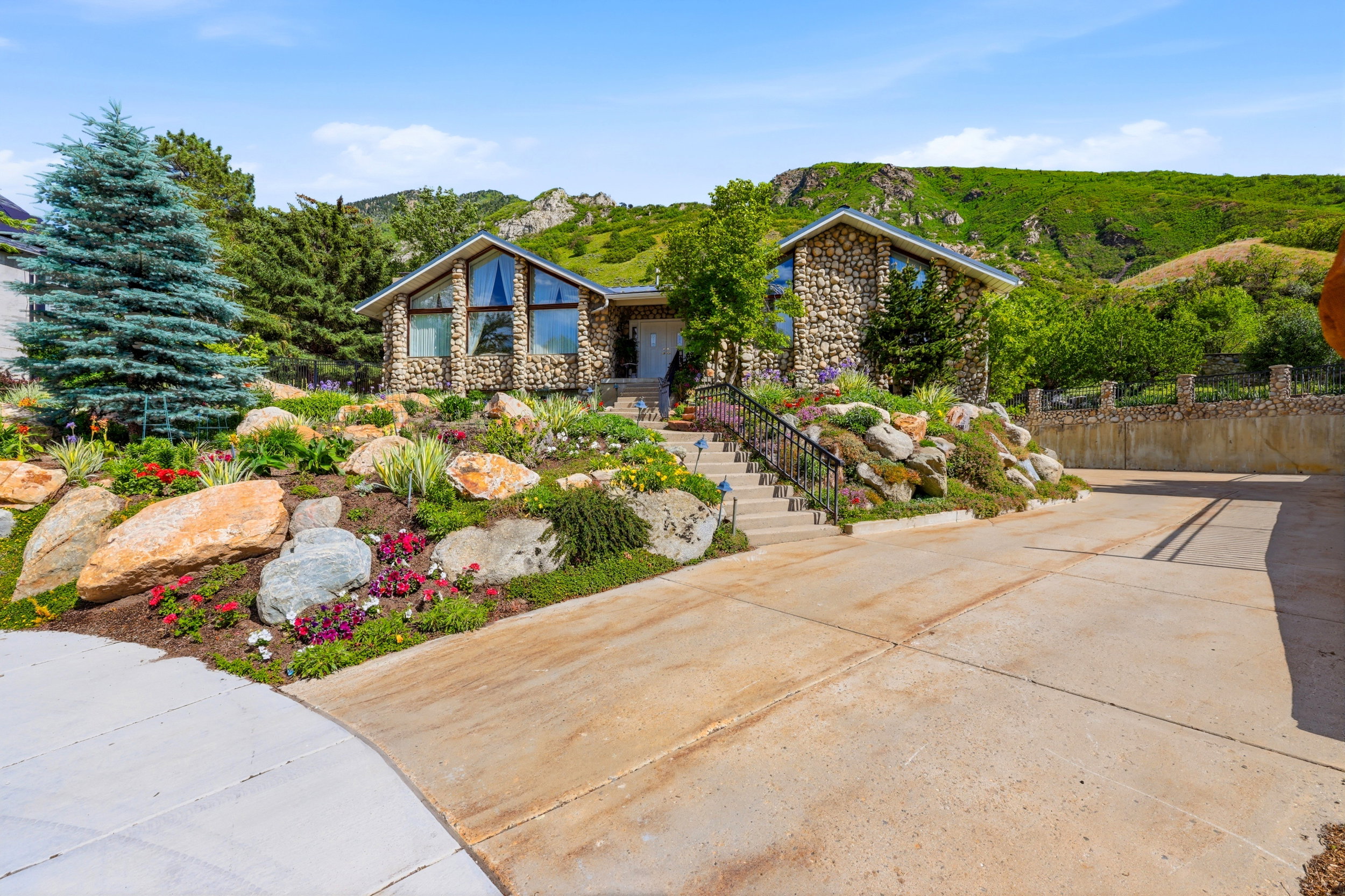 Stone-clad exterior featuring a prominent A-frame window design