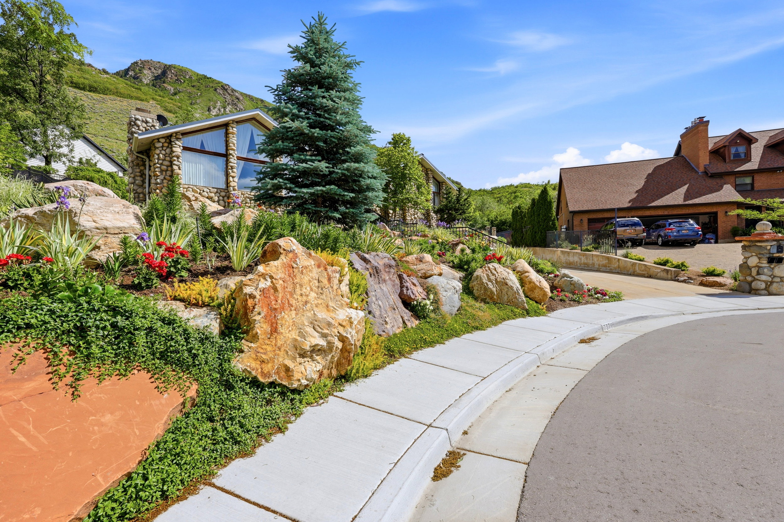 Stone exterior residence with a prominent A-frame window design