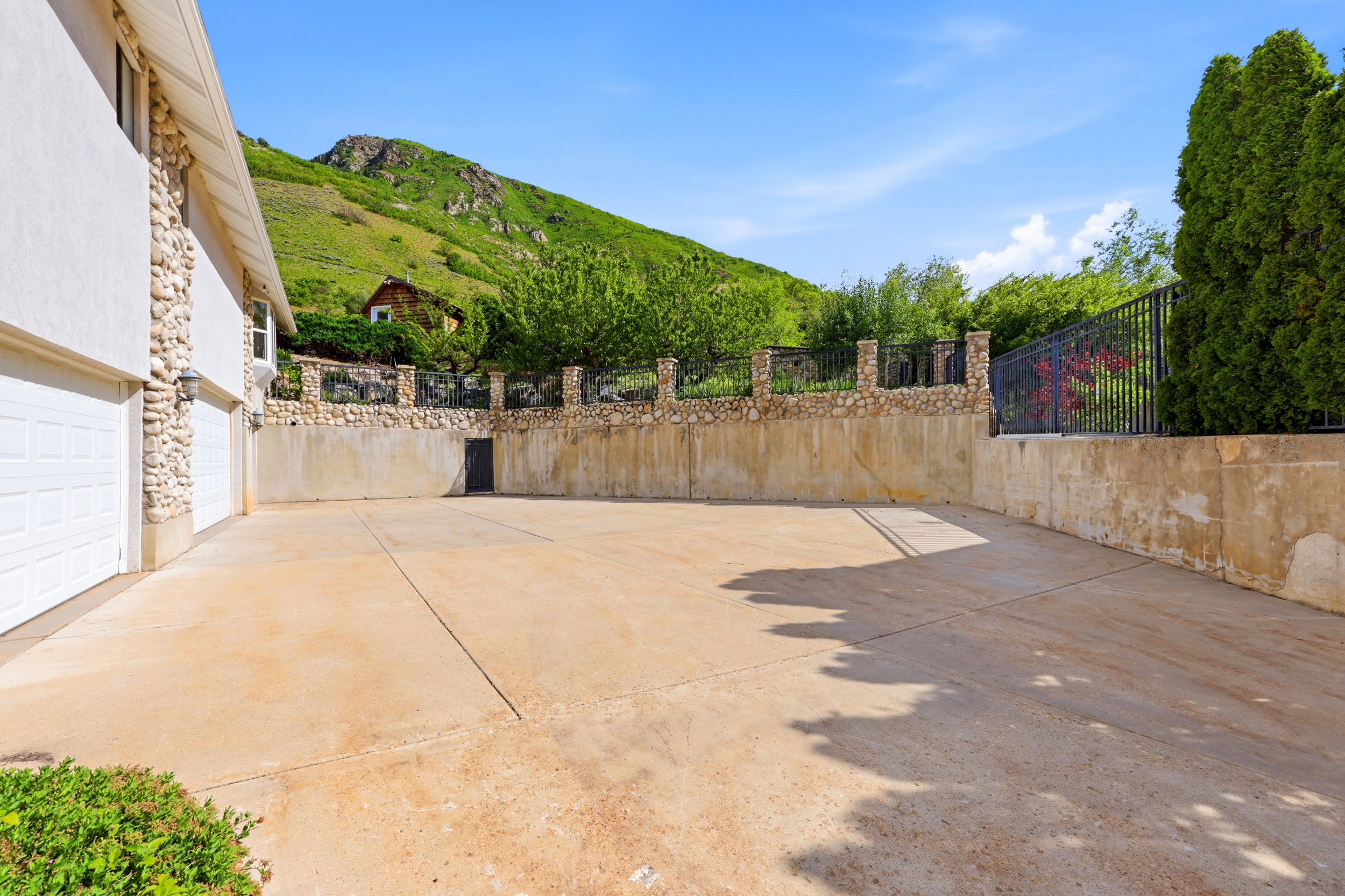 Expansive concrete drive with a three-car garage