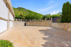 Expansive concrete drive with a three-car garage