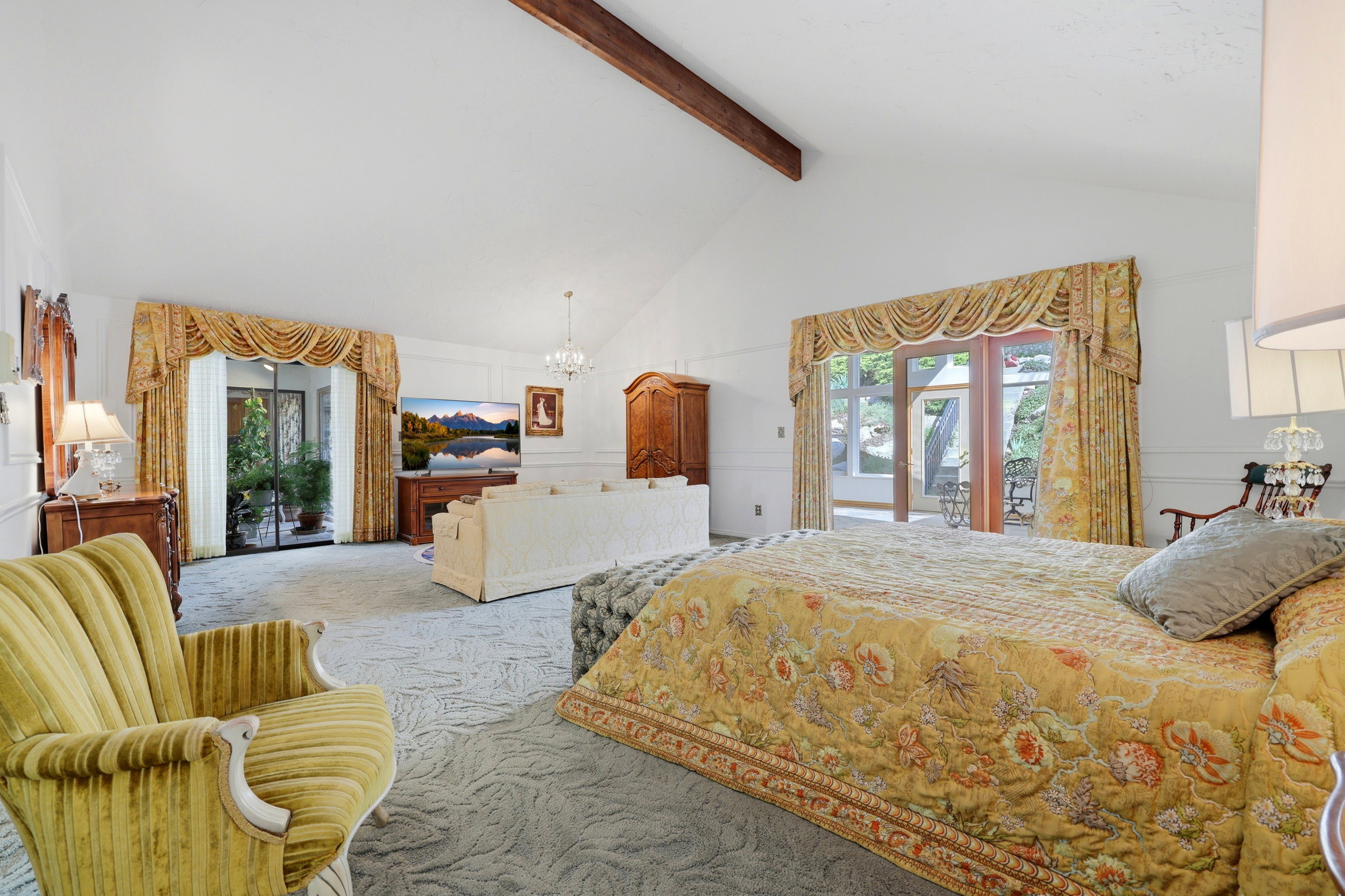Vaulted white ceilings with exposed wood beam