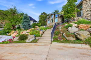 Stone-clad exterior featuring a tiered landscape design