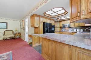 Kitchen featuring light wood cabinetry and countertops