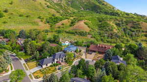 Expansive property featuring a multi-level residence with a blue roof, situated on a terraced lot