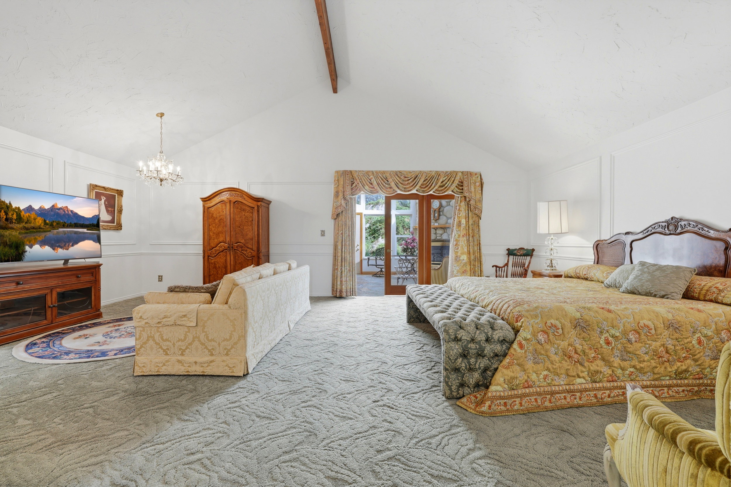 Spacious room with vaulted ceilings, wall paneling, and patterned carpeting