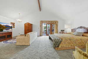 Spacious room with vaulted ceilings, wall paneling, and patterned carpeting