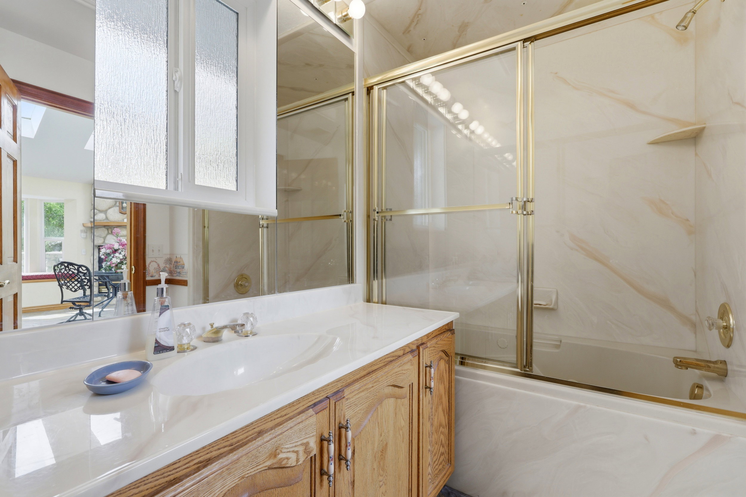 Vanity with an integrated sink, polished chrome faucet, and wood-finish cabinetry