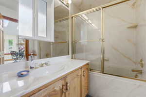 Vanity with an integrated sink, polished chrome faucet, and wood-finish cabinetry