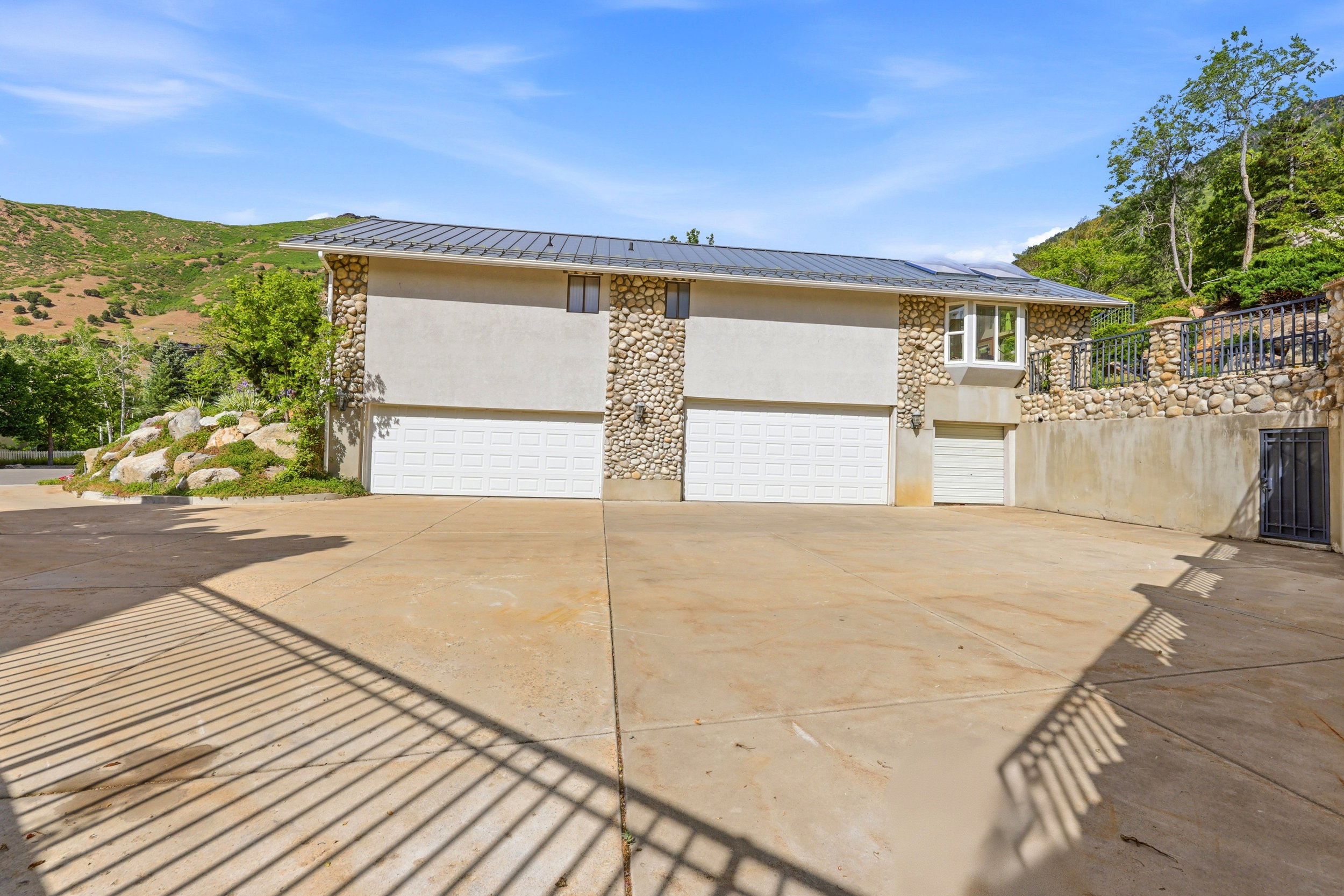 Multi-bay garage with three white sectional doors