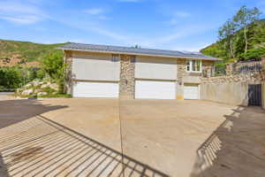 Multi-bay garage with three white sectional doors