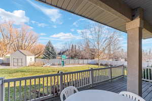 Covered outdoor deck with a gray wood-finish surface and a matching railing