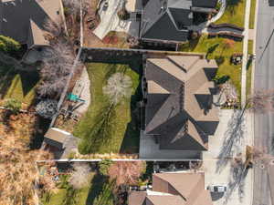 Expansive property featuring a multi-gabled roofline, concrete driveway, and a large manicured lawn