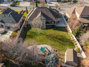 Expansive residential property featuring a large backyard, mature landscaping, and a multi-level home with a covered patio