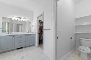 Dual vanity with light gray cabinetry, integrated sinks, and polished chrome faucets