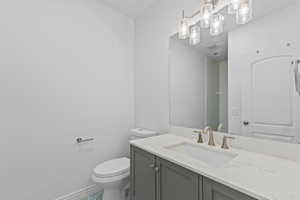 Modern bathroom featuring a contemporary vanity with a stone-finish countertop and an undermount sink