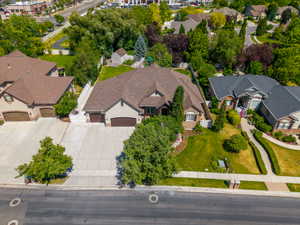 Ranch-style residence featuring a multi-gable roofline, attached two-car garage, and a concrete driveway