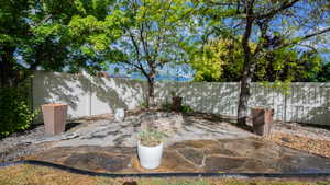 Expansive flagstone patio area featuring a built-in stone fire pit