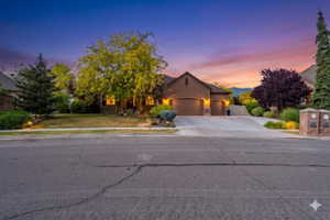 Exterior featuring a stucco facade, two-car garage, and a concrete driveway
