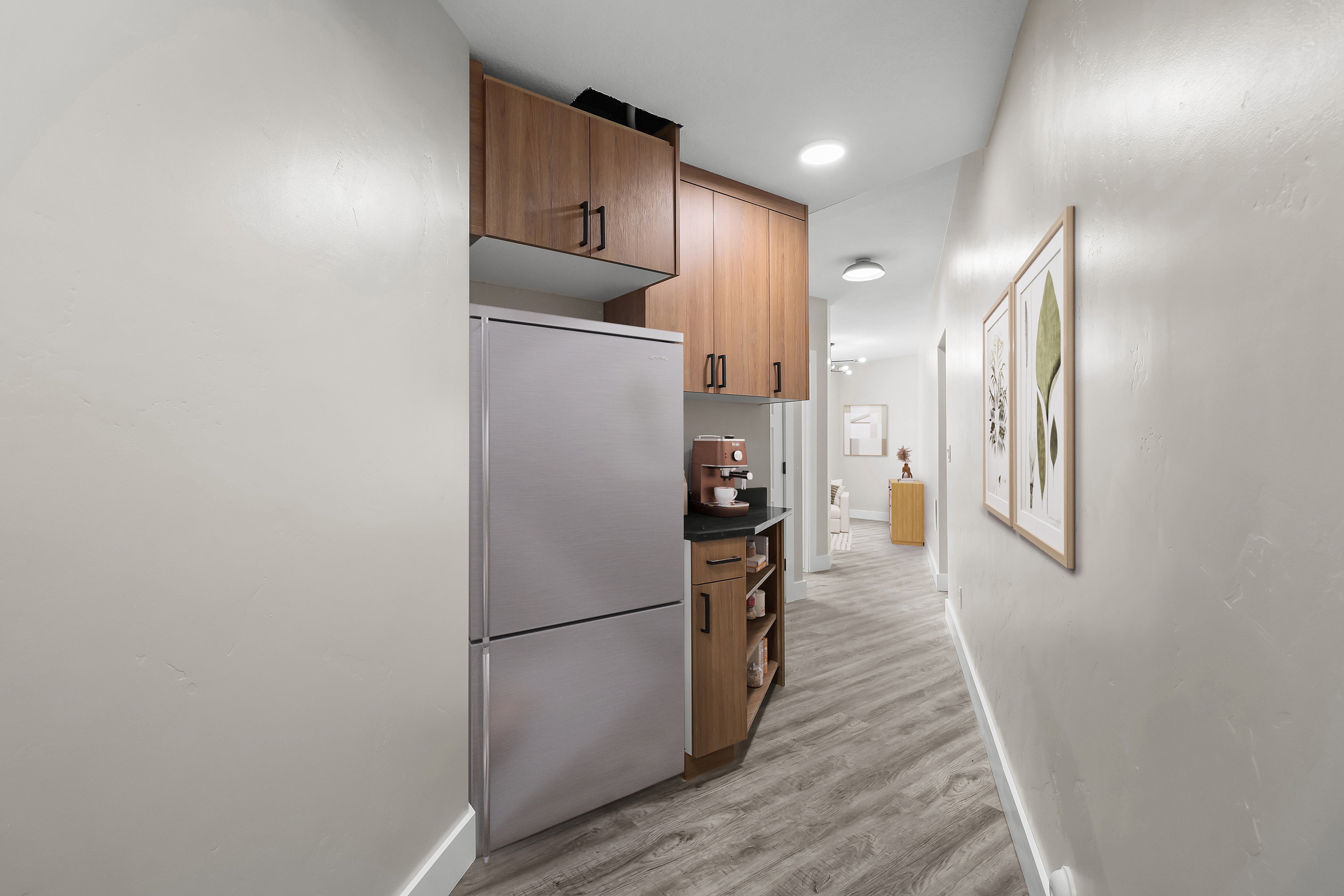 ADU * 2nd Kitchen * VIRTUALLY STAGED Hallway kitchenette with wood-finish cabinetry and a stainless steel refrigerator