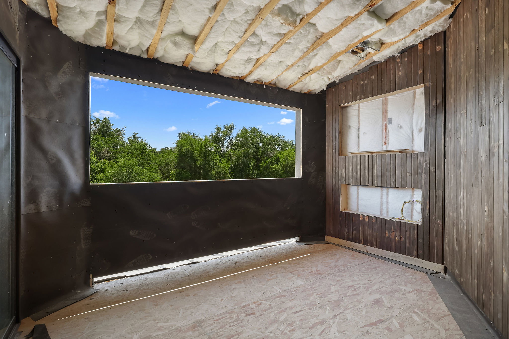 1 OF 2 OPEN PATIOS!  FIREPLACE TO BE INSTALLED! Expansive window opening framing mature trees and blue sky