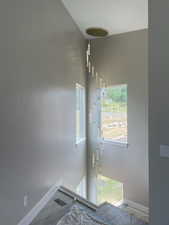 Two-story foyer featuring a contemporary multi-tier chandelier with individual cylindrical glass pendants