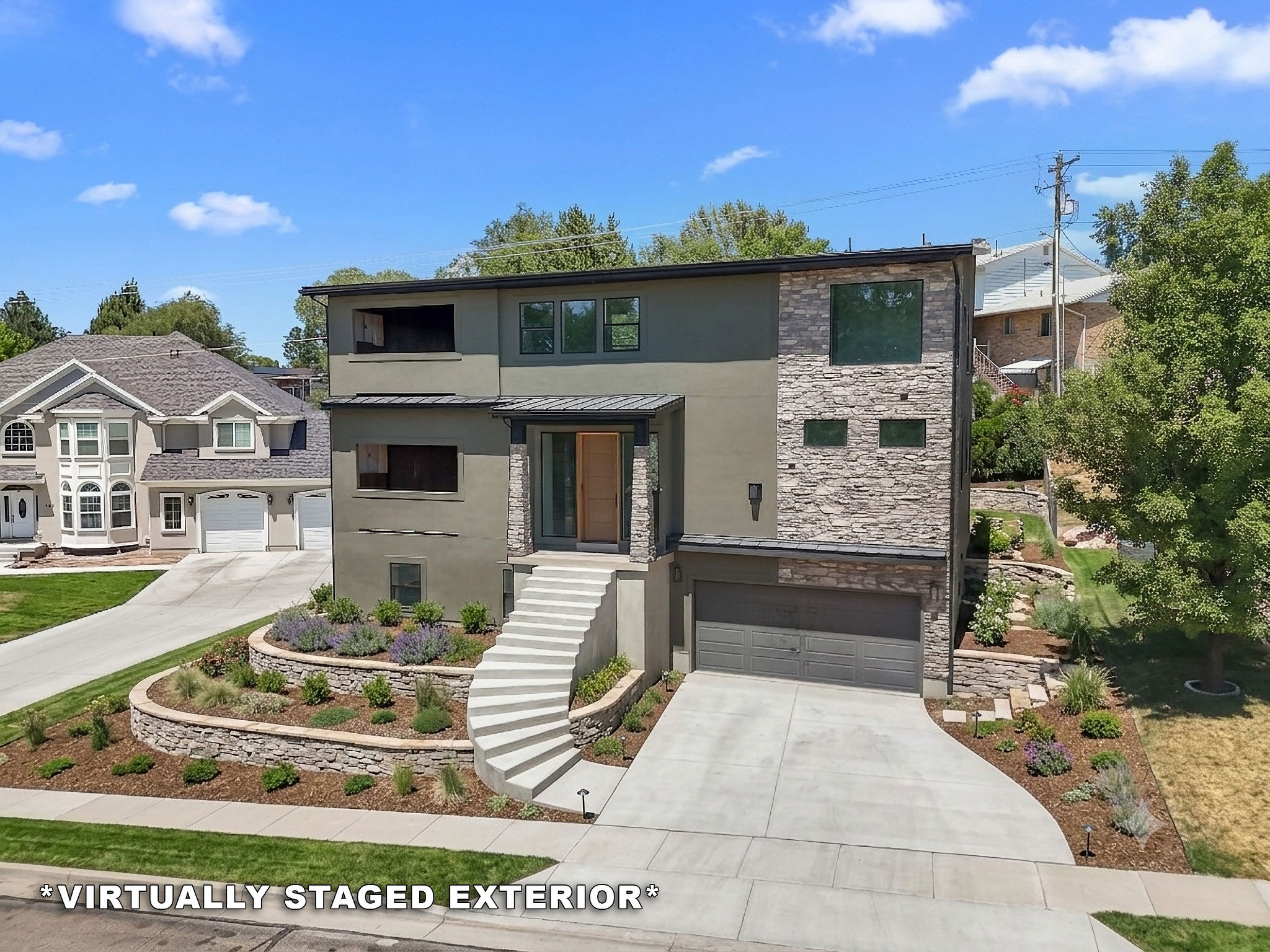 VIRTUALLY STAGED EXTERIOR!  Contemporary exterior featuring stone accents and a multi-level design