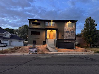 Contemporary two-story residence featuring a stone and stucco facade